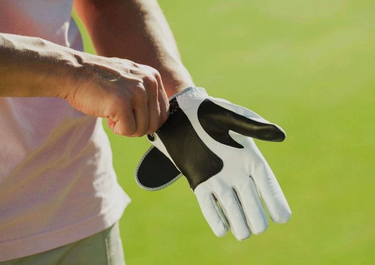 man wearing a black and white golf glove