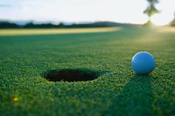 a golf ball near the cup